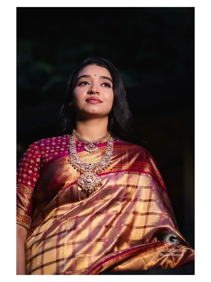Priyanka looking regal for her post wedding reception. The makeup is more defined for the evening, with a focus on her eyes, complementing her rich silk saree and statement diamond jewelry.