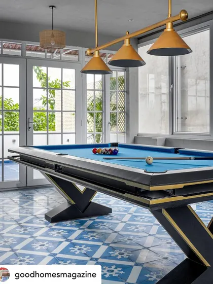 A feature from Good Homes Magazine on 'Mina Nivas', highlighting the terrace lounge with its vibrant blue tiles and custom pool table. The space is a perfect blend of recreation and style.