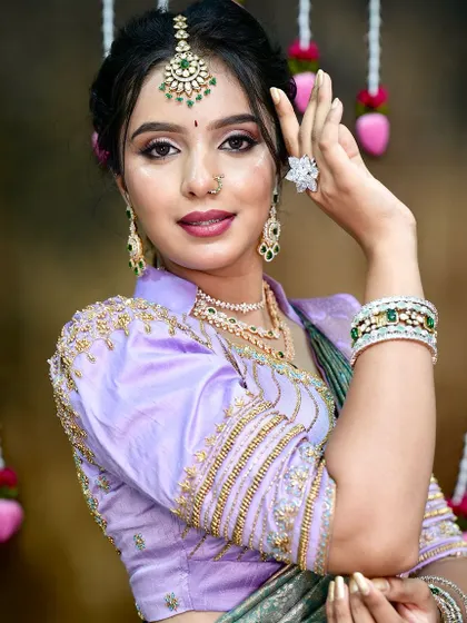 A classic bridal look featuring a lavender and sea-green silk saree. The glass skin makeup and diamond jewelry complement the saree's modern color palette, perfect for a daytime wedding or reception.