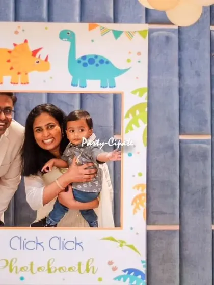 A fun moment captured in the dinosaur-themed photo booth. It's always wonderful to see families having a great time and making memories.