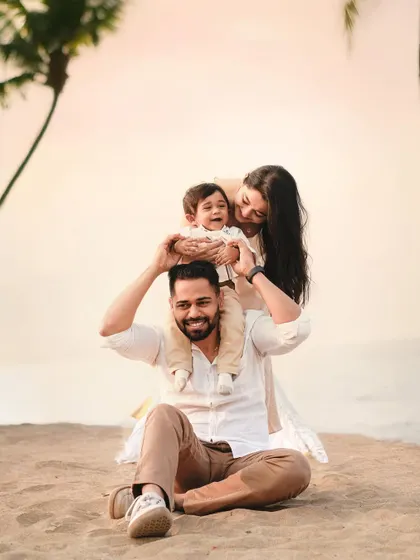 A classic "on the shoulders" pose during a family beach session. It's a playful way to create connection and capture joyful expressions against a beautiful seaside backdrop.