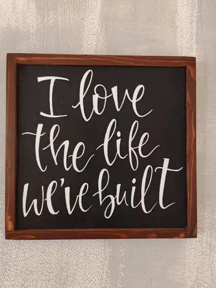 A simple reminder of what truly matters. This hand-painted wooden sign, "I love the life we've built," is a beautiful piece of gratitude to display in your home.