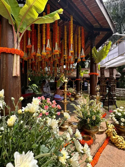 A close-up of a traditional Muhurtham setup, showing the beautiful floral arrangements and brass lamps.