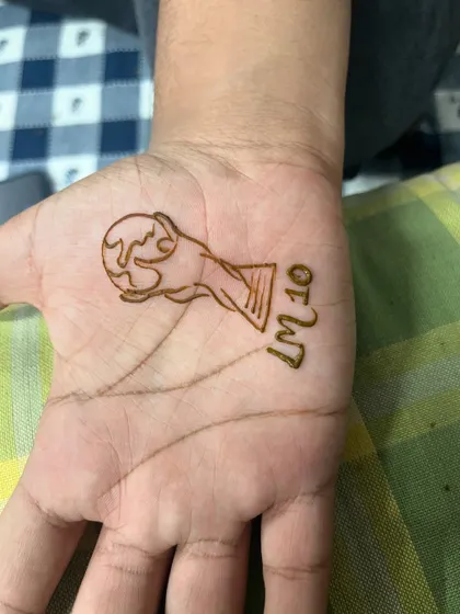 A fun request for a football fan, a simple design of the World Cup trophy with "LM10" for Lionel Messi.