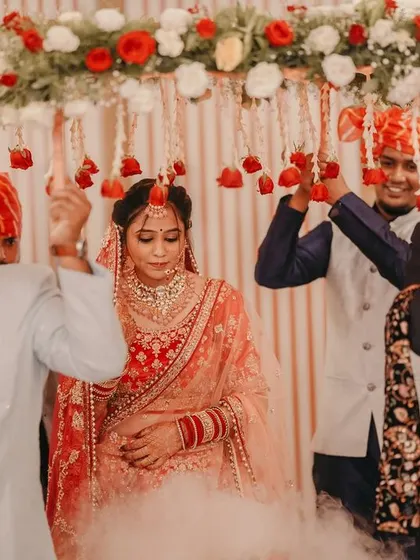 The bride's grand entrance under a floral canopy, a classic and beautiful wedding moment.