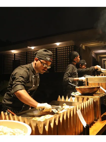 Our chefs working at a live teppanyaki-style grill, providing entertainment and delicious food for guests.
