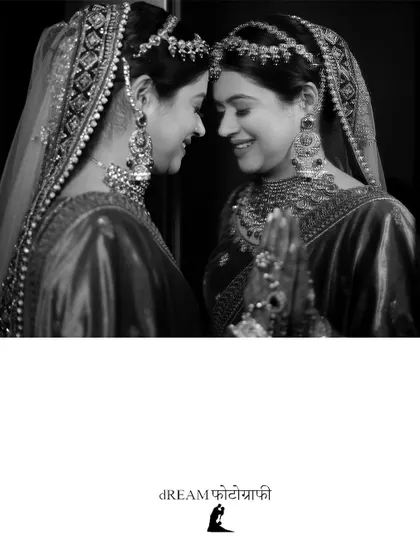 A touching black and white photo of bride Kashika, her reflection creating a beautiful symmetrical portrait.