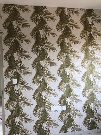 A full wall covered in the green palm leaf pattern, creating a bold and refreshing accent wall.
