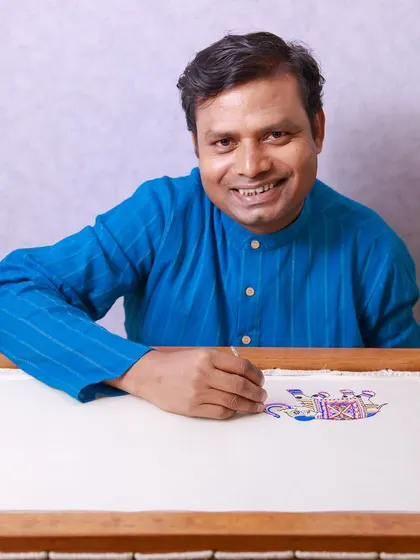 Our embroidery artisan, Mukhtaar ji, ensuring every detail of a client's story is conveyed perfectly through his craft. He dives into the depths of detail to bring your vision to life.