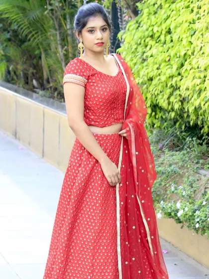 Elegance in red. This classic red lehenga features a subtle all-over gold print and a simple, beautifully cut blouse, proving that sometimes the most timeless designs are the most impactful.