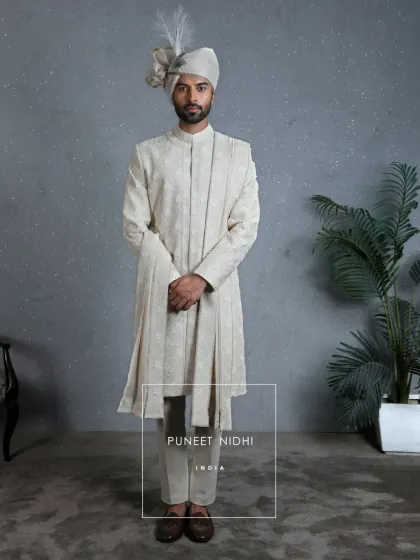 A full view of the 3D floral ivory sherwani, complete with a matching stole. The entire look is designed to reflect the emotions woven into every detail of a wedding.