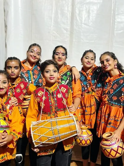 Teamwork makes common people achieve uncommon results. Our folk dance team poses in their vibrant costumes, ready to take the stage.