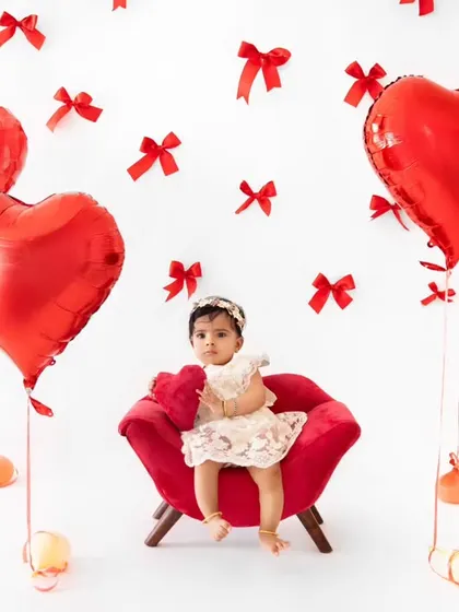 A sweet Valentine's Day setup with a baby girl surrounded by heart-shaped balloons. I offer themed mini-sessions for various holidays throughout the year.
