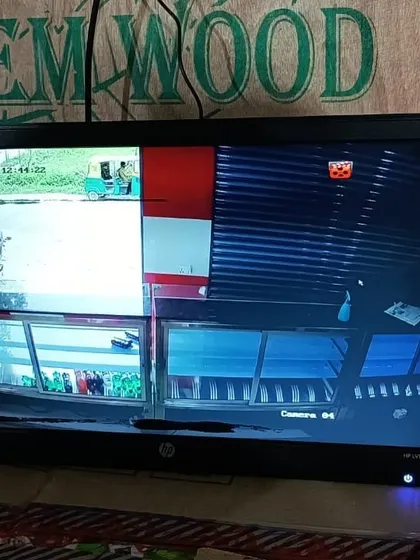 A four-way split on the monitor, showing both interior and exterior views of the shop.
