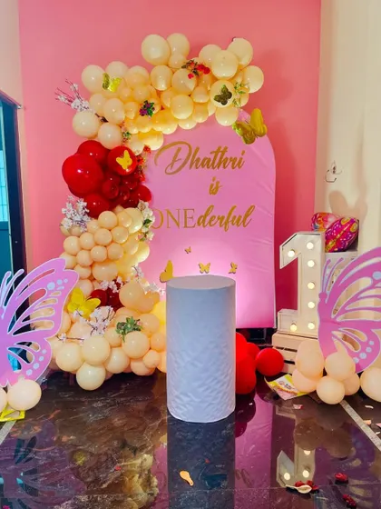 A beautiful Butterfly theme for a "onederful" first birthday, featuring a pastel balloon garland and large butterfly wing cutouts.