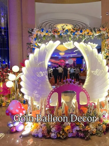For a magical welcome party, I designed this enchanted butterfly theme. The large, backlit angel wings create a stunning focal point, complemented by a princess carriage, mushroom props, and a mix of floral and balloon decorations.