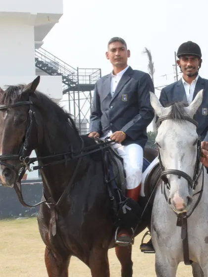 A portrait of two of our senior riders on a black and a grey horse, representing the experience within our team.