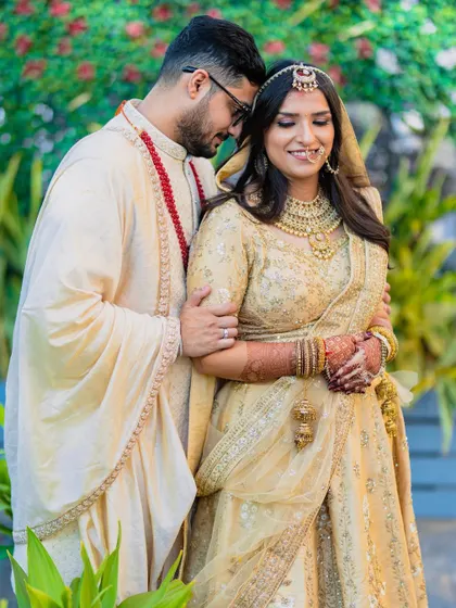 A tender and happy moment. The groom's embrace and the bride's smile say everything about their love story.