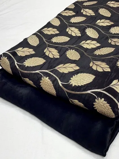 The classic combination of black and gold is shown in this crepe jacquard set. The woven pattern adds a luxurious texture, making it suitable for evening wear or formal kurtas.