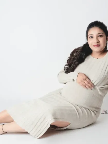 This classic seated portrait in black and white is all about the peaceful anticipation of motherhood. The clean background keeps the focus on the beautiful mom-to-be.