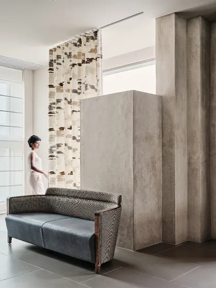 We used folded geometric forms in the walls to create distinct zones and backdrops for furniture displays. This approach allows for the creation of intimate vignettes within the large, open-plan showroom.