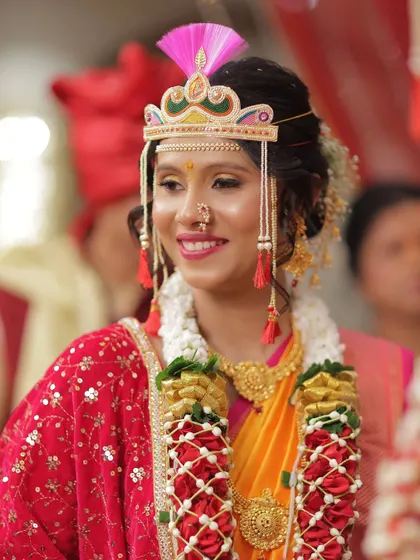 A close-up of the bride's joyful expression. Her makeup is soft and pretty, with a focus on enhancing her smile and the sparkle in her eyes.