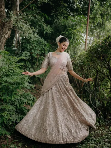 A beautiful portrait in a garden setting. The bride's smile and the flowing lehenga create a picture of pure elegance and happiness.
