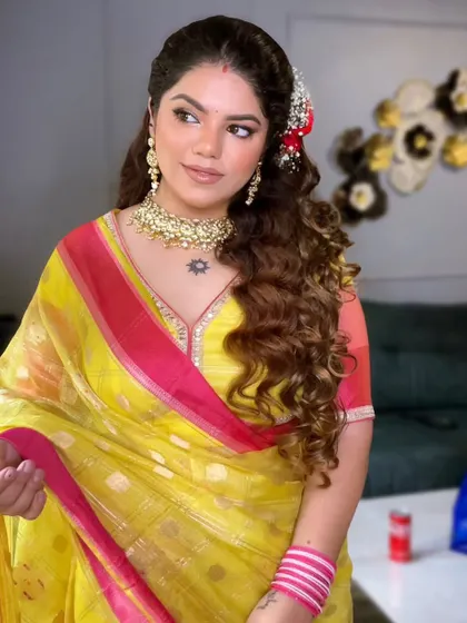 The full look for my Diwali celebrations. A bright yellow and pink saree with soft curls in my hair.