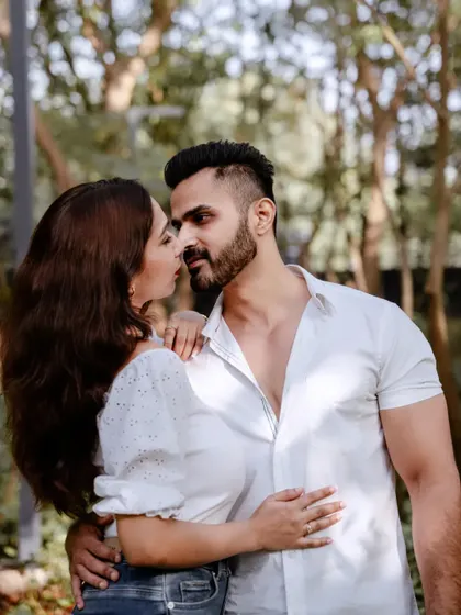 An intimate and romantic close-up of a couple in a lush green park, perfect for a pre-wedding couple photoshoot.