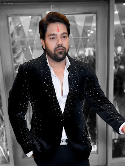 A client looking dapper in a black velvet blazer with scattered silver embellishments. This design is a favorite for its balance of classic style and modern flair.