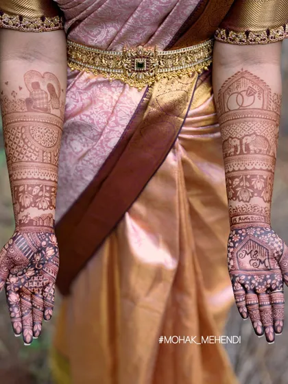 This photo shows the fresh, dark stain of a personalized bridal mehndi. The design includes the couple's initials, wedding rings, and other love story elements, all beautifully highlighted by the deep color.