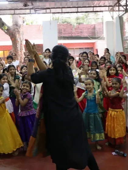 Leading the children in a group activity. Movement and song are integral parts of our storytelling sessions.