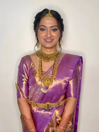 A smiling bride radiating happiness. Her soft glam makeup, with a focus on glowing skin and a neutral lip, allows her natural beauty and the stunning jewelry to shine.