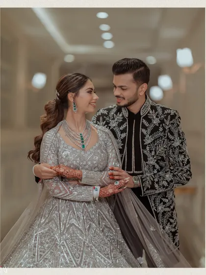 A happy, candid portrait of the couple, their smiles lighting up the frame.