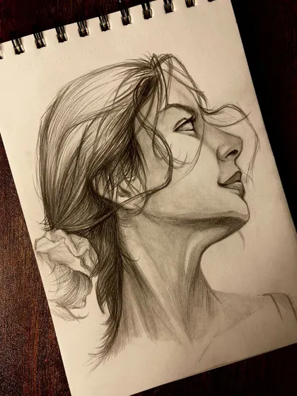A different perspective of the female profile sketch, highlighting the shading on her neck and face.