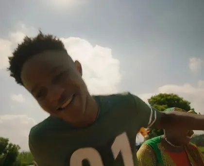 A happy, candid moment captured during the SanDisk shoot. The simple green jersey with number detailing adds a sporty, youthful element to the character's look.