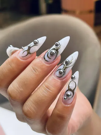 The sharp stiletto shape combined with fluid 3D chrome accents creates a look that is both edgy and artistic. We love creating these wearable sculptures.