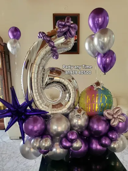 A 6th birthday balloon bouquet in purple and silver chrome, with a starburst foil balloon for extra flair.