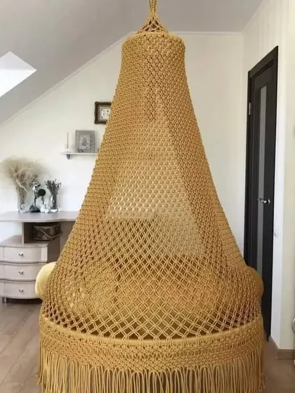 A full view of our golden-yellow swing, showing how it can be a beautiful centerpiece in a room with a high or slanted ceiling.