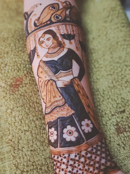 A finished bridal figure on an arm, showcasing a full-length portrait with detailed clothing and jewelry. This is the kind of advanced work my course prepares you for.