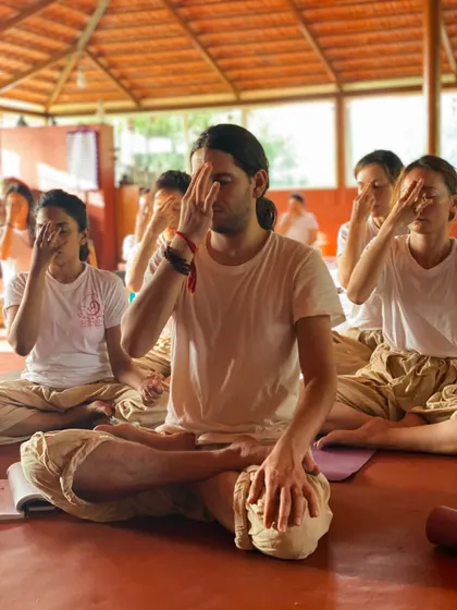 A student practices Nadi Shodhana (Alternate Nostril Breathing), a pranayama technique to balance the left and right hemispheres of the brain and calm the mind. This is a cornerstone of our daily practice.