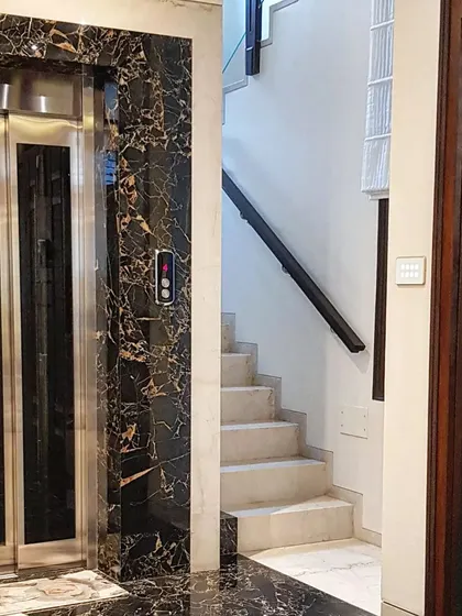 In this luxury residence, a custom touch panel is installed next to a marble-clad elevator, showcasing how our technology integrates seamlessly into high-end architectural designs.