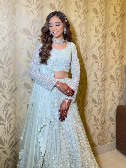 This is what I call glass skin glam. For this bride's reception, I created an ultra-dewy, reflective complexion paired with a soft, glossy lip and shimmering eyes.