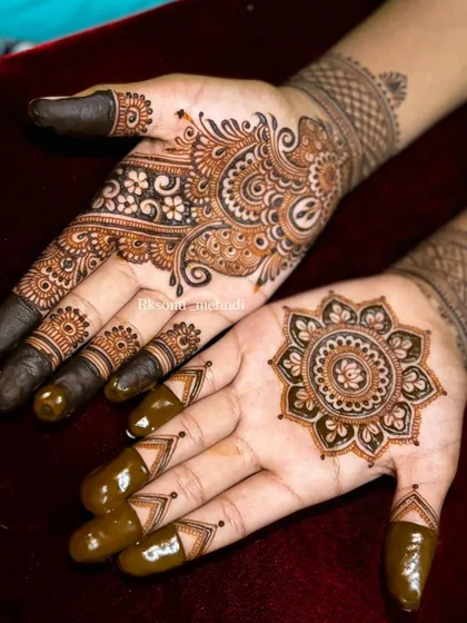 This is a beautiful example of an asymmetrical design. One hand features a classic mandala, while the other is adorned with a flowing paisley pattern, creating a balanced yet modern look.