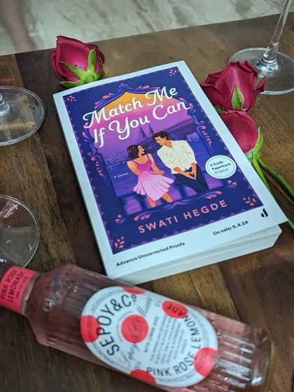 An advance copy of *Match Me If You Can* with some pink rosé lemonade, celebrating the journey of this book.
