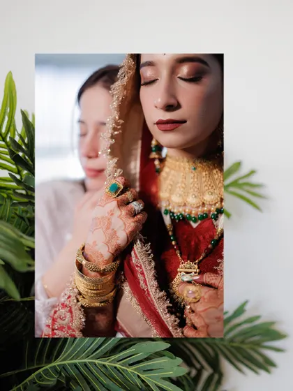An artistic portrait of the bride, with a loved one's gentle touch, symbolizing the support and love surrounding her on her wedding day.