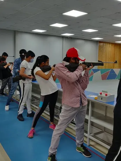 The same group of shooters from a slightly different angle, all focused on their targets. Repetition and practice are the keys to success.