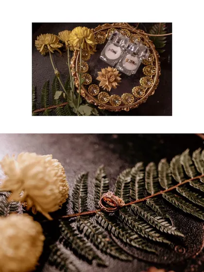 A detailed shot of the engagement rings, beautifully arranged with flowers and ferns, highlighting the intricate details of the jewelry.