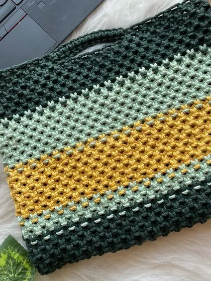 Yes, I make laptop bags too. This custom piece features bold stripes of forest green, mustard yellow, and mint, offering a unique and stylish way to protect your tech.