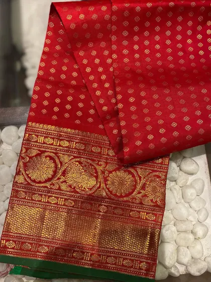 A stunning red Kanjeevaram blouse piece with all-over butti work and a grand border. A single piece like this can elevate any silk saree in your wardrobe.